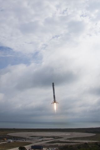 The first stage of a SpaceX Falcon 9 rocket lowers down toward the ground after launch on Feb. 19, 2017.