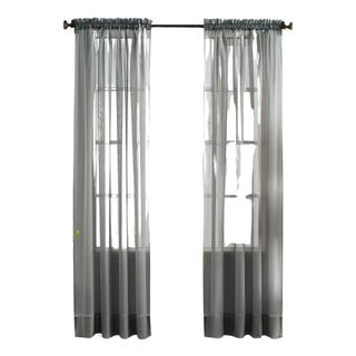 Grey sheer curtains on a black curtain rail