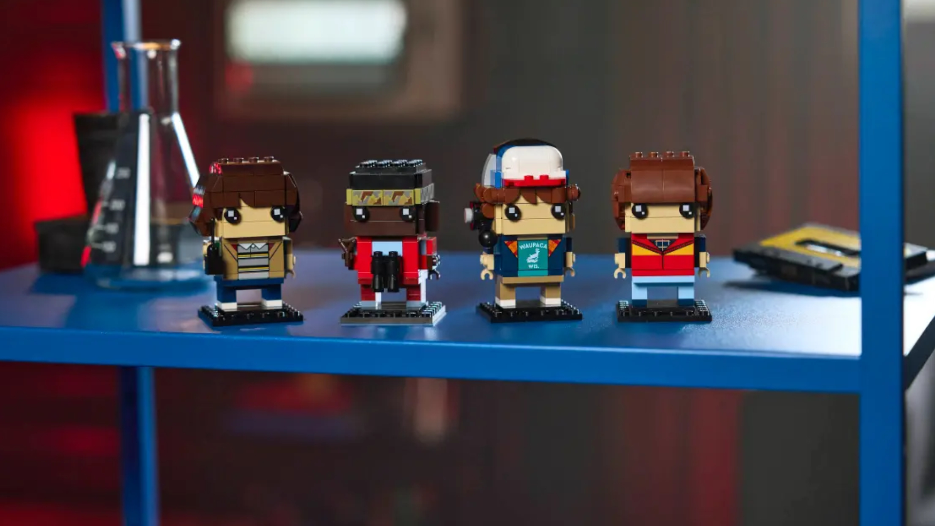 Lego Mike, Dustin, Lucas, and Will Figures on a blue shelf