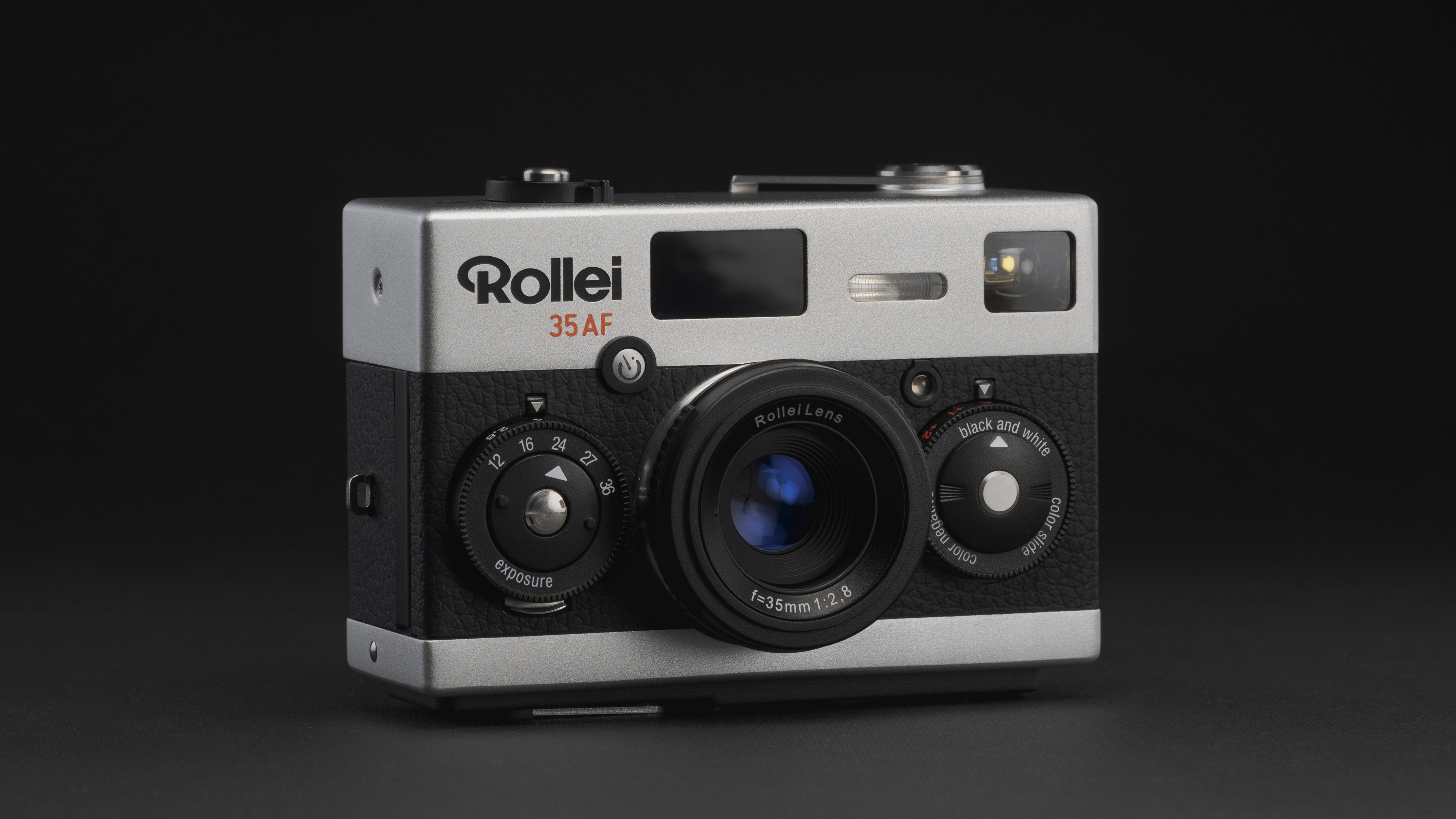 Rollei 35AF film camera on grey surface and black background