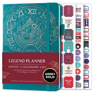 A teal blue goal planner with gold detailing