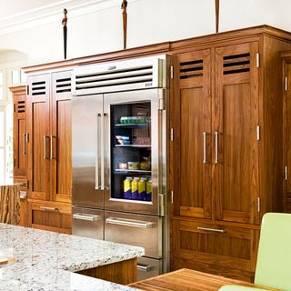 kitchen area with wooden cupboard and fridge