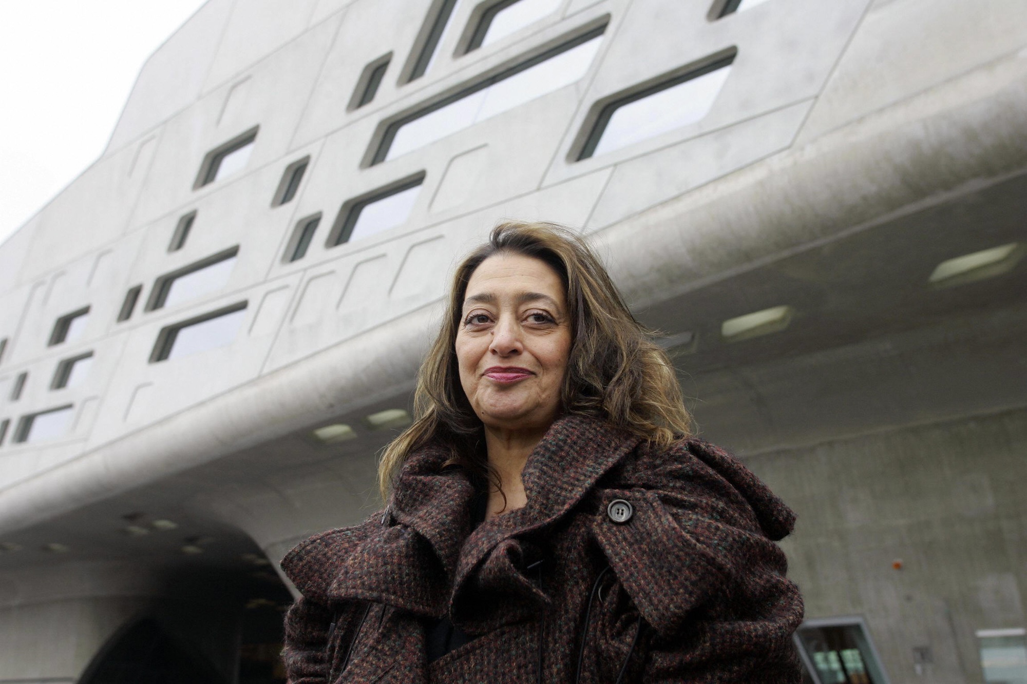 architect Zaha Hadid standing in front of a building