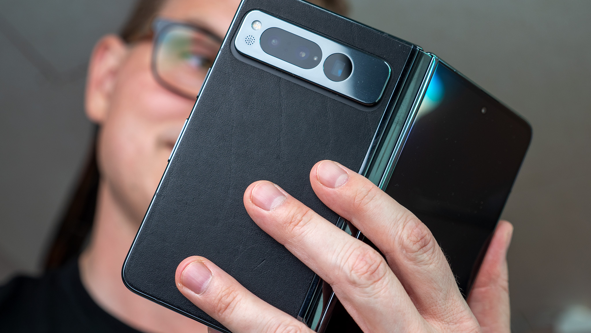 Reading something on the large screen of the Google Pixel Fold with a Dbrand leather skin
