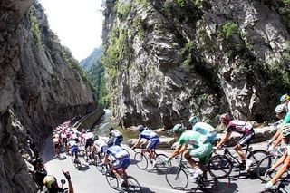 The peloton making its way along this beautiful river.