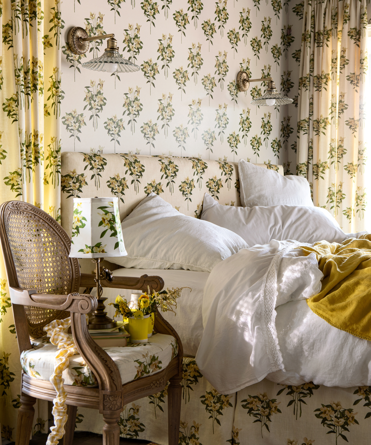 a bedroom drenched in a yellow and green floral pattern