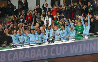Manchester City’s Vincent Kompany celebrates with the trophy alongside team-mates after the final whistle during the Carabao Cup Final