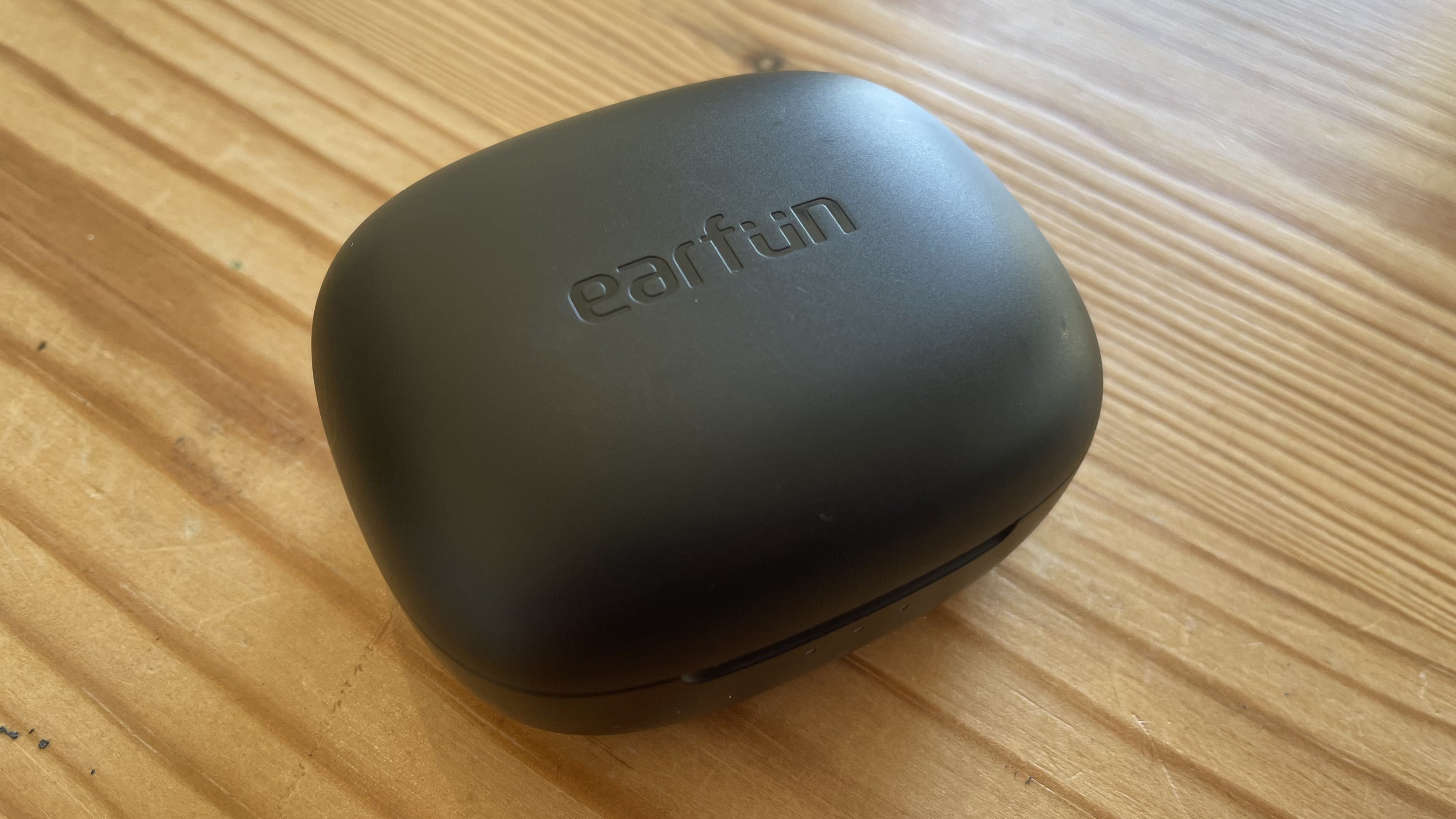 Earfun Air Pro 3 case closed on wooden table