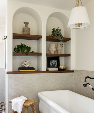 Modern Spanish bathroom shelving filled with organic shaped and wooden decor