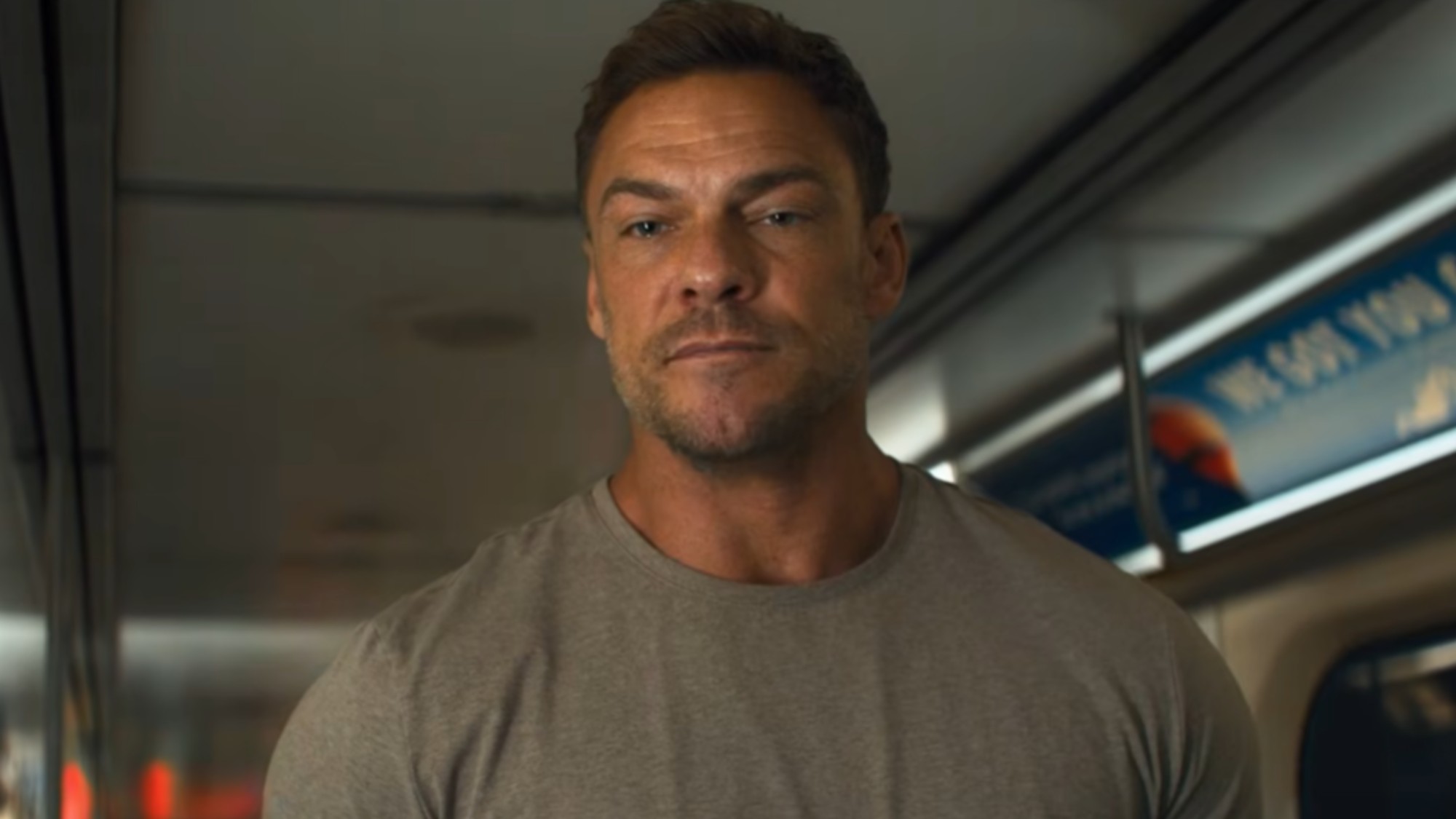 Alan Ritchson as Jack Reacher on the subway.