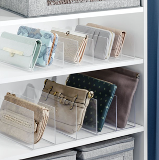 Clear plastic purse organizers displayed on shelves with purses positioned within them.