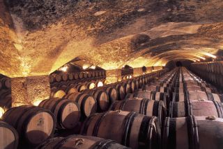 Wine barrels maturing in a winery, Meursault Castle, Burgundy.