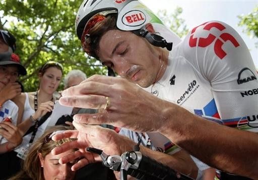 Cancellara wipes away the sweat after his ride.
