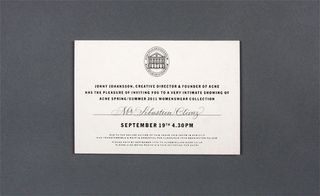 Back view of Acne's invitation pictured against a grey background