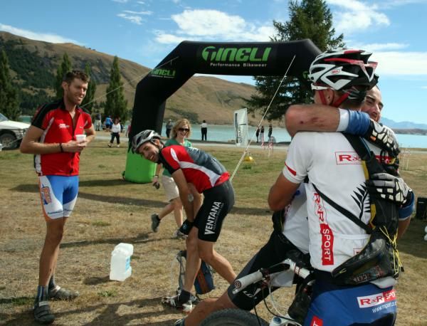 Champions: Team R&amp;R Sport's Tony Hogg, of Dunedin, and Mark Williams, of Queenstown, celebrate winning the 2010 Alpine Epic Multi-Stage Mountain Bike Race in a time of 17:04:06 at Lake Tekapo on Saturday. Second placed team members Brent Miller (left), and Ollie Whalley, both of Christchurch, look on.