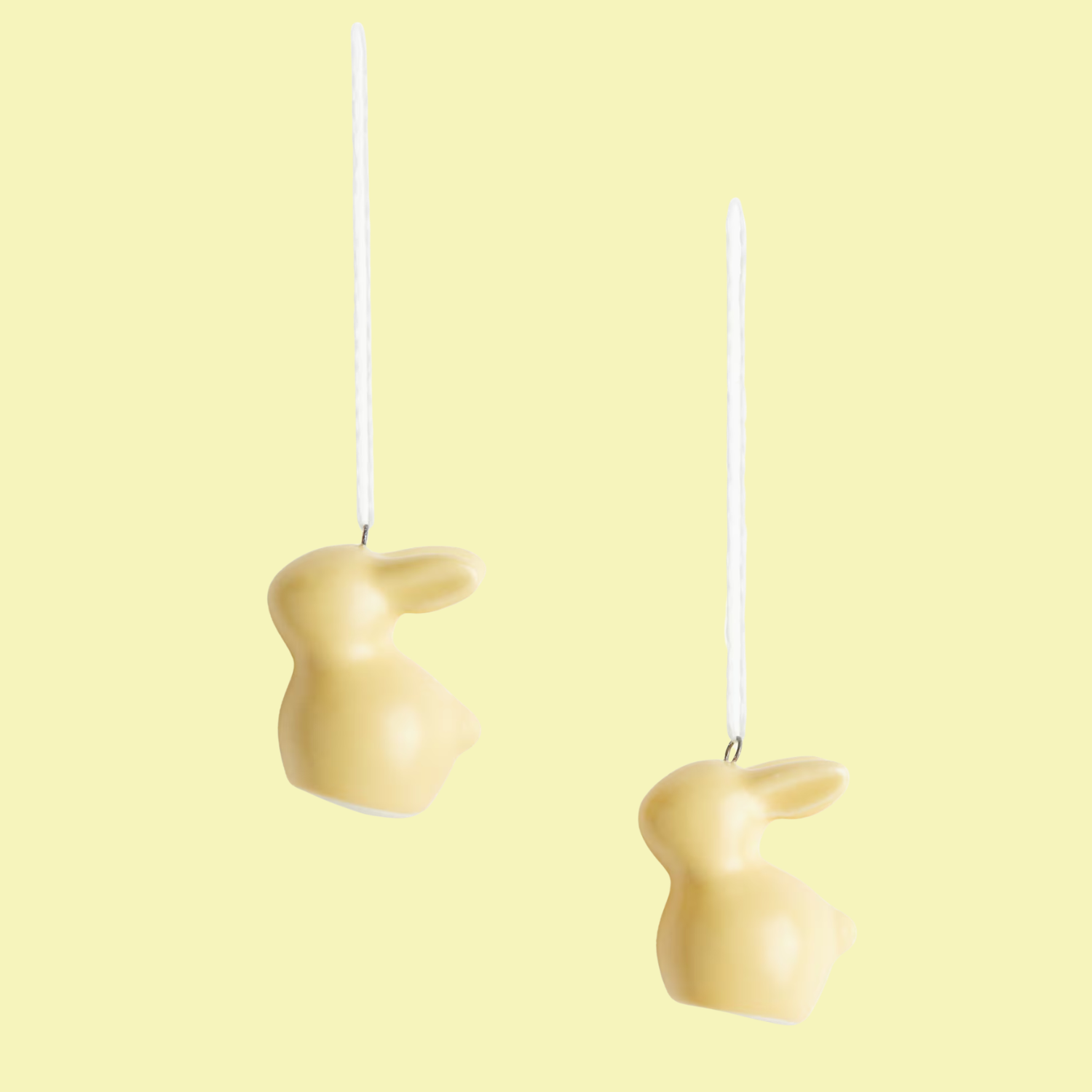 A set of two yellow bunny-shaped ornaments