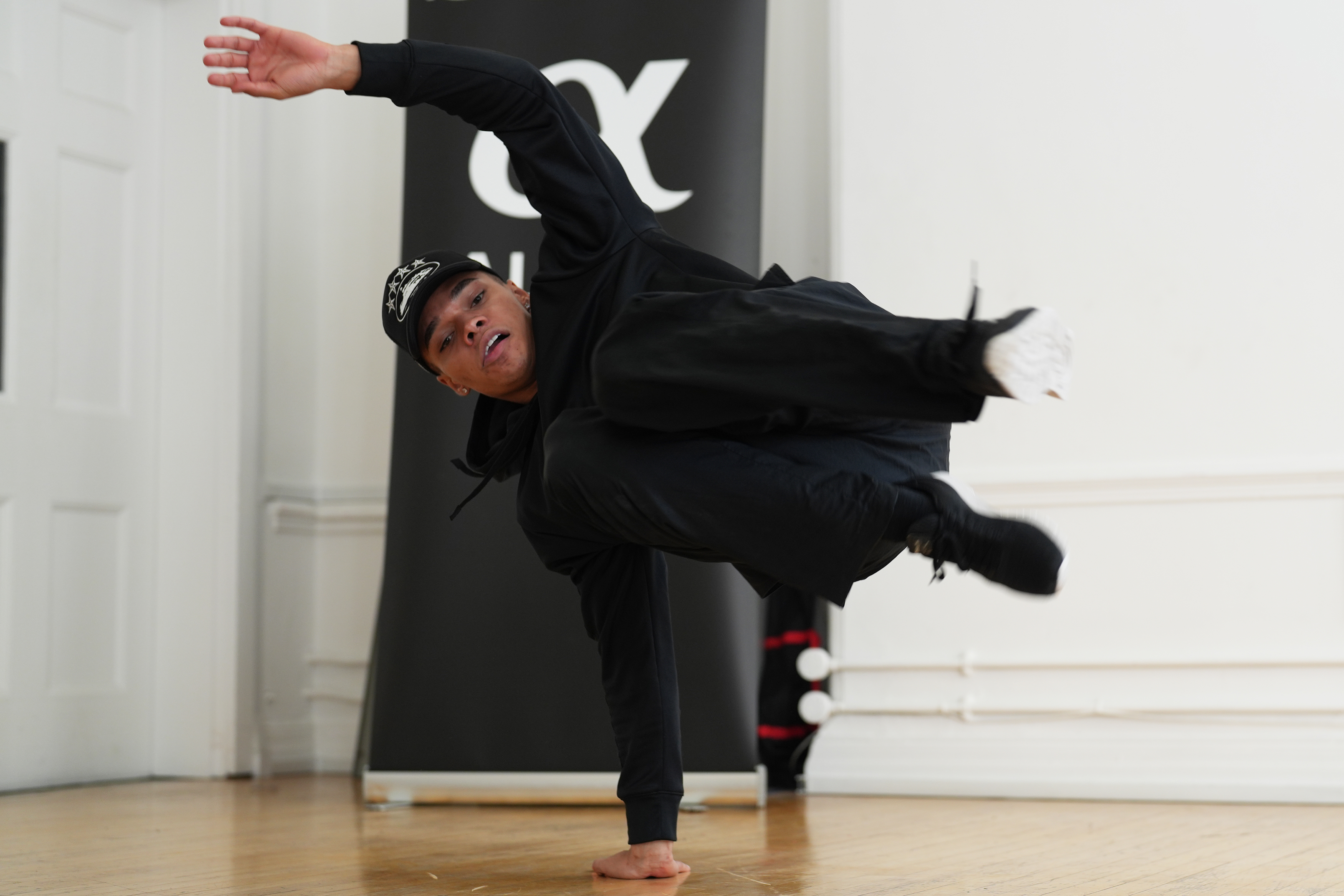 A man break dancing in a studio