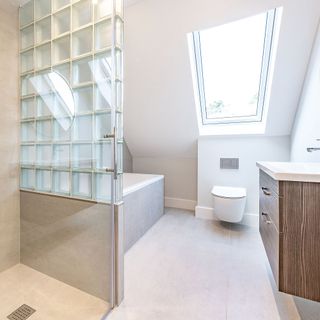 Bathroom with glass brick wall at the end of the bath