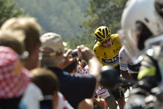 Chris Froome climbs through the crowds during stage 14.