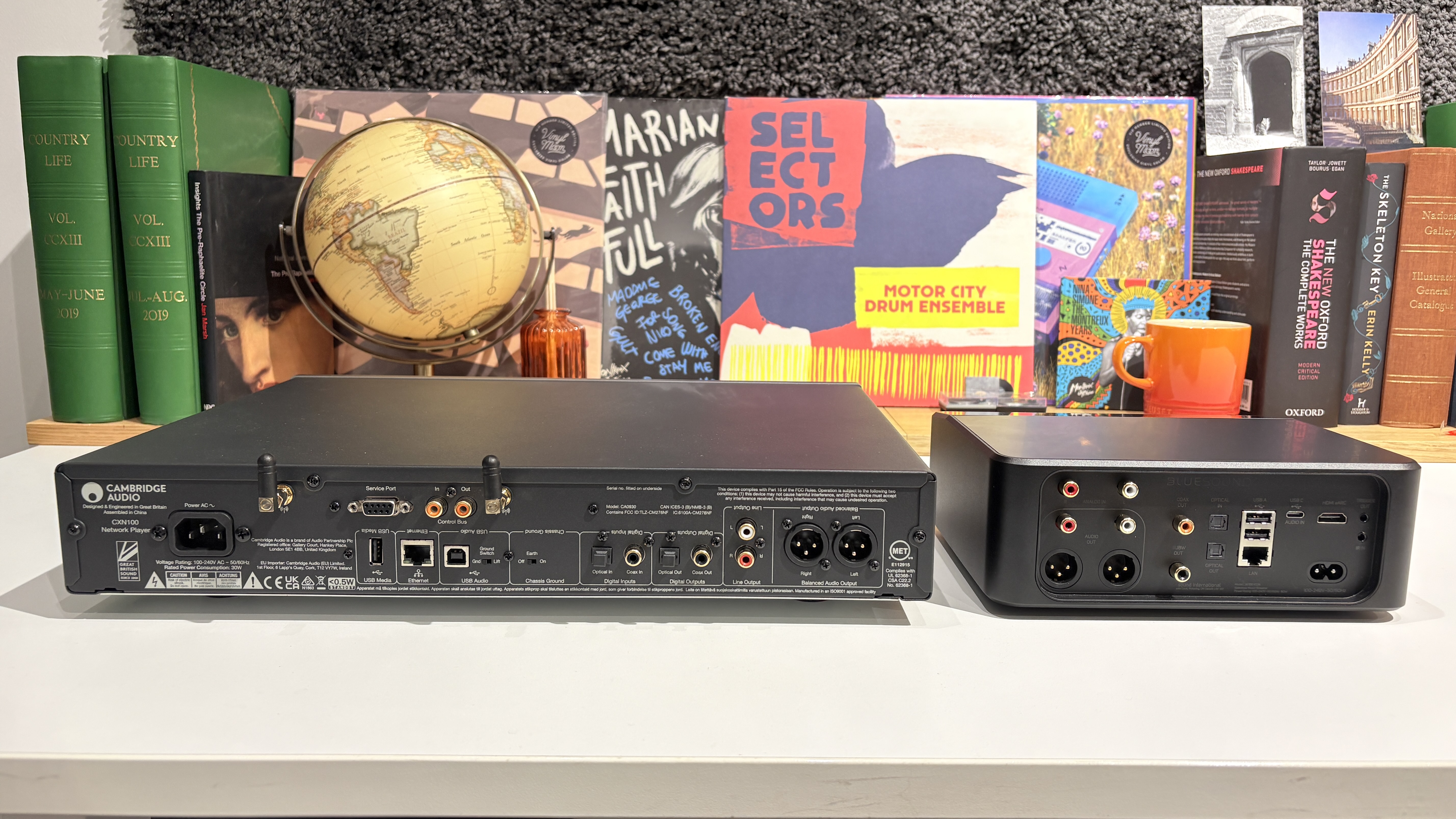 Bluesound Node Icon and Cambridge Audio CXN100 streamers placed next to each other on a white desk