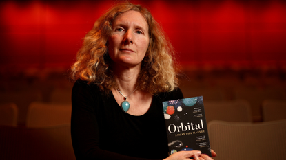 Samantha Harvey, winner of the Booker Prize 2024, with her book Orbital.