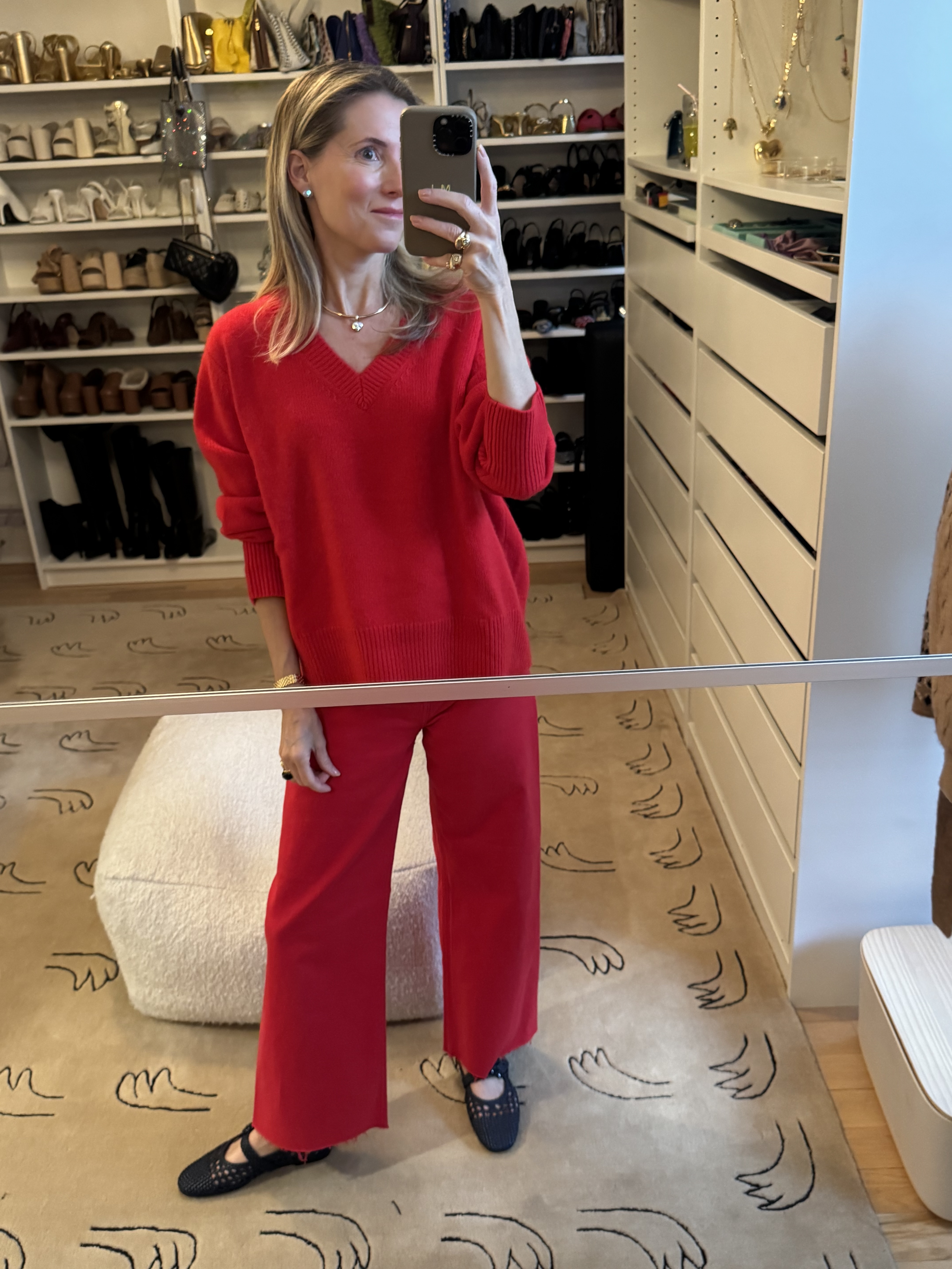 Marina Larroud&amp;eacute; wearing red jeans with a red sweater and navy flats