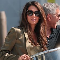 Amal Clooney arrived at the 2026 Venice Film Festival in a silky pair of shorts layered beneath a blazer
