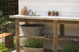 outdoor sink ideas: bench with pots