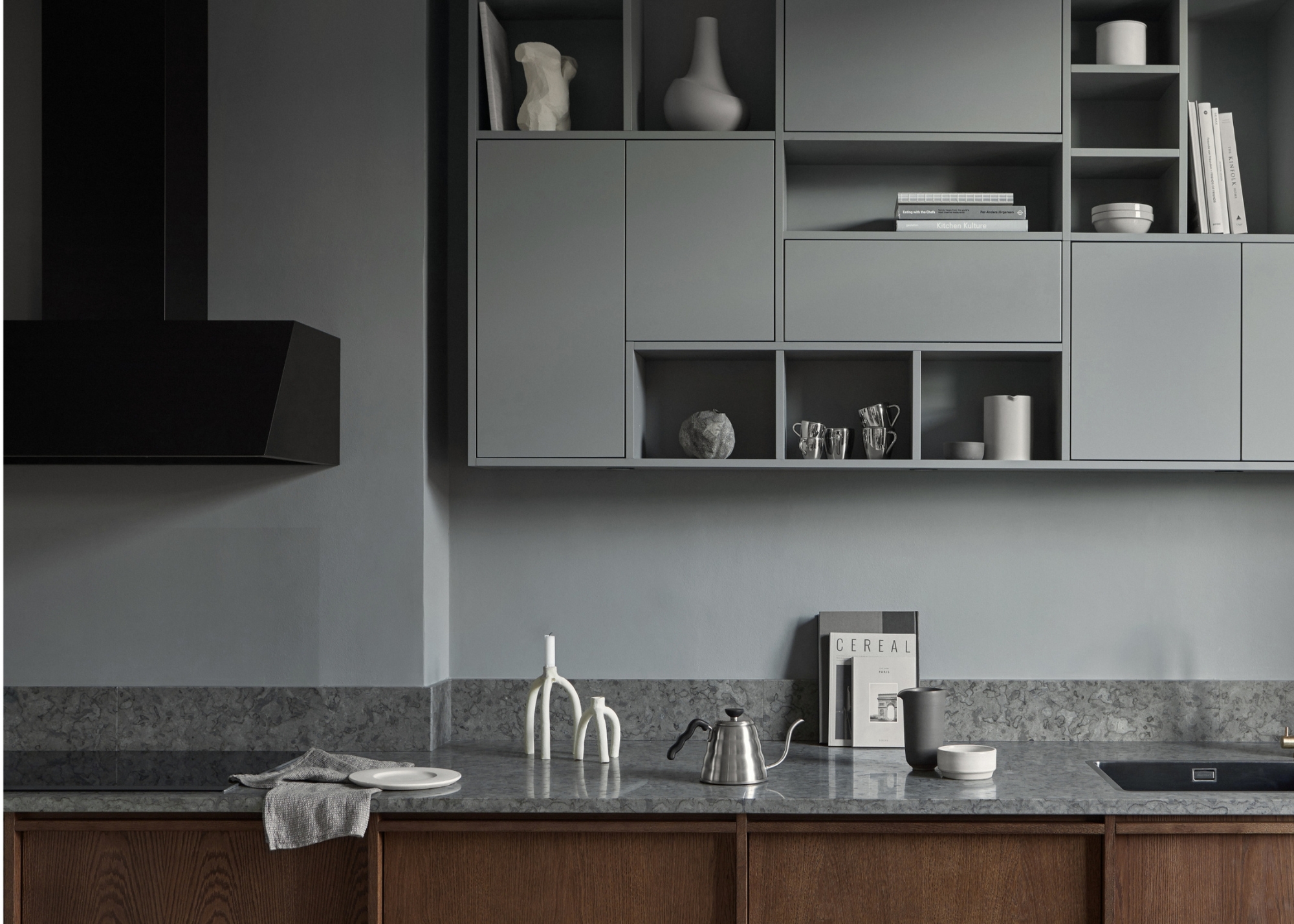 A grey drenched kitchen with dark wood cabinetry