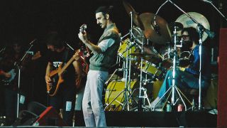 Frank Zappa performs on stage with band members (L-R) Denny Walley, Arthur Barrow, Ike Willis (patially hidden) and drummer Vinnie Colaiuta at The Knebworth Festival on September 9th, 1978 in Knebworth, United Kingdom.