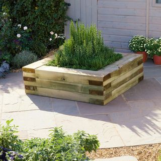 Square wooden garden planter with herbs