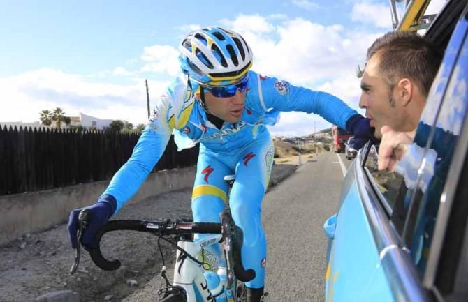 A rider drops back to the team car to talk to Gorazd Strangelj