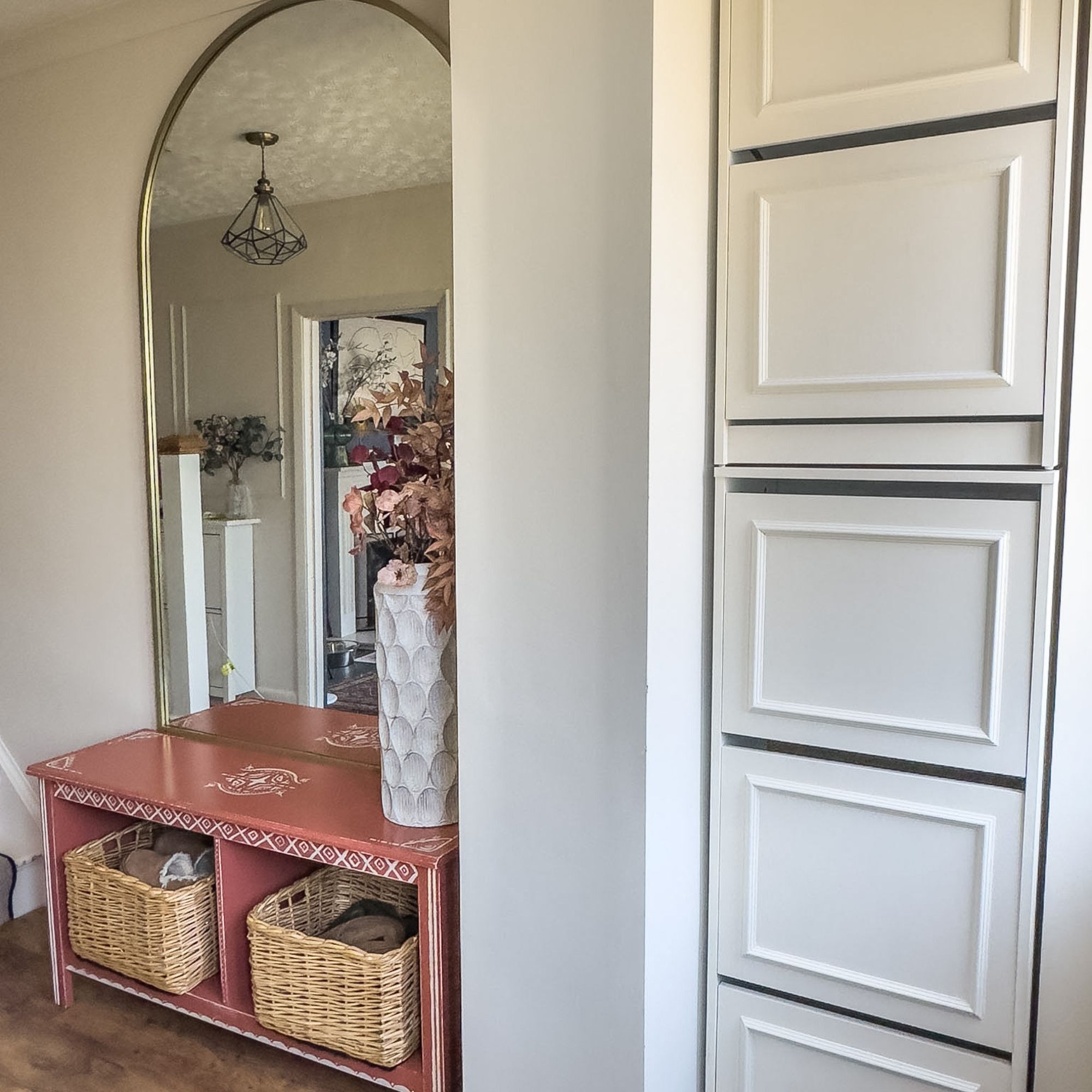 IKEA Bissa shoe storage hack in a hallway, next to a pink seating area and mirror