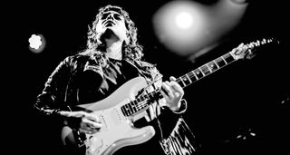 A black-and-white live shot of Bonnie Trash guitarist Emmalia Bortolon-Vettor playing a Fender Strat.