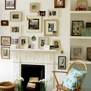 living room white walls pictures on wall with chair with cushions