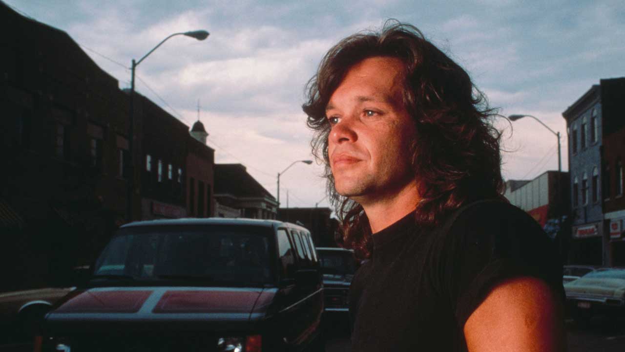 John Mellencamp crossing a street in 1980