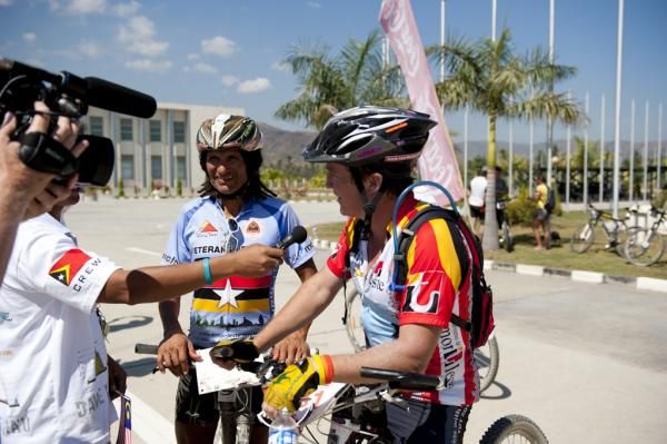 Racers, including Tinker Juarez, chat after the finish