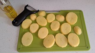 Sliced potatoes on chopping board