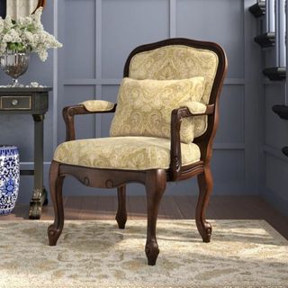 A wooden chair with yellow upholstery
