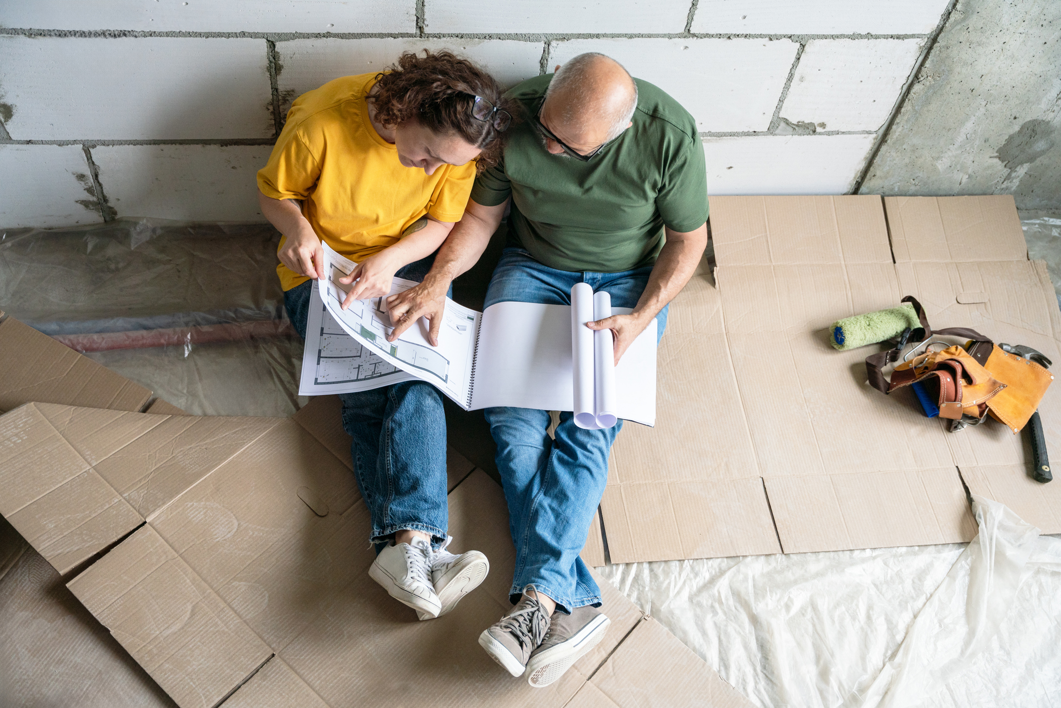 Couple Planning Home Renovation Together in a Construction Setting