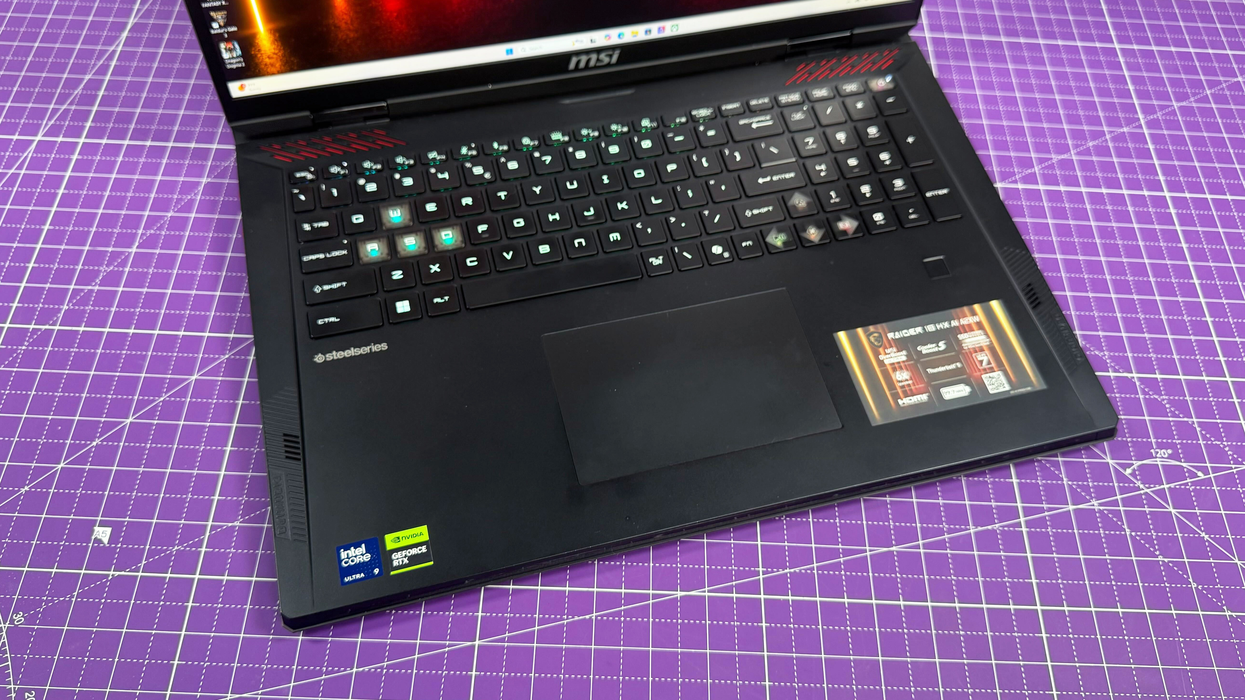 The MSI Raider 18 HX AI gaming laptop's keyboard from above, against a purple mat.