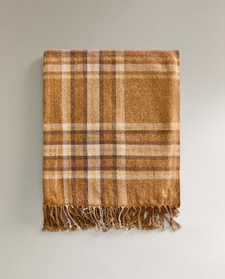 a checked chenille blanket in shades of yellow