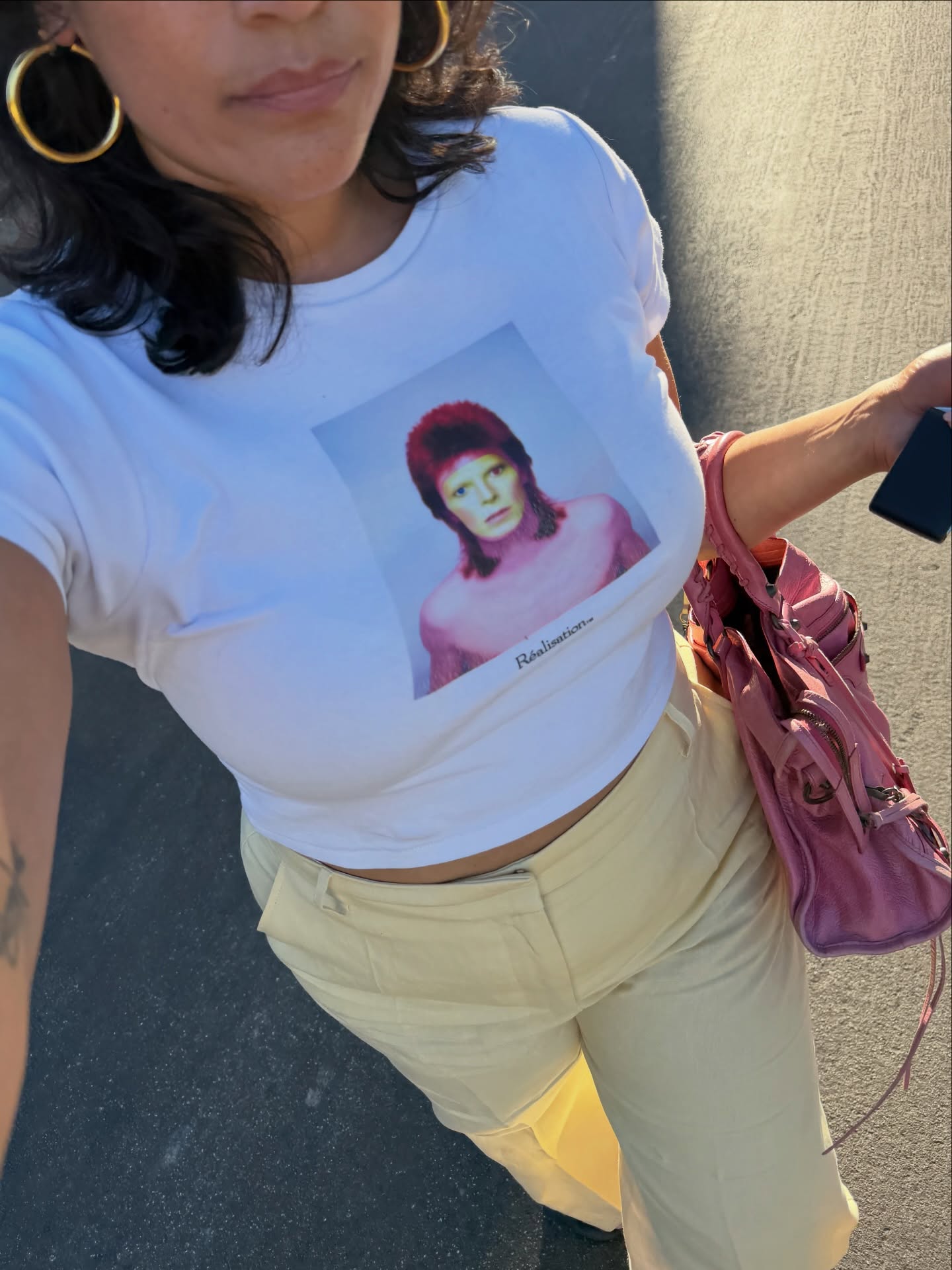 Jennifer Atilemile wearing a graphic tee and butter yellow jeans.