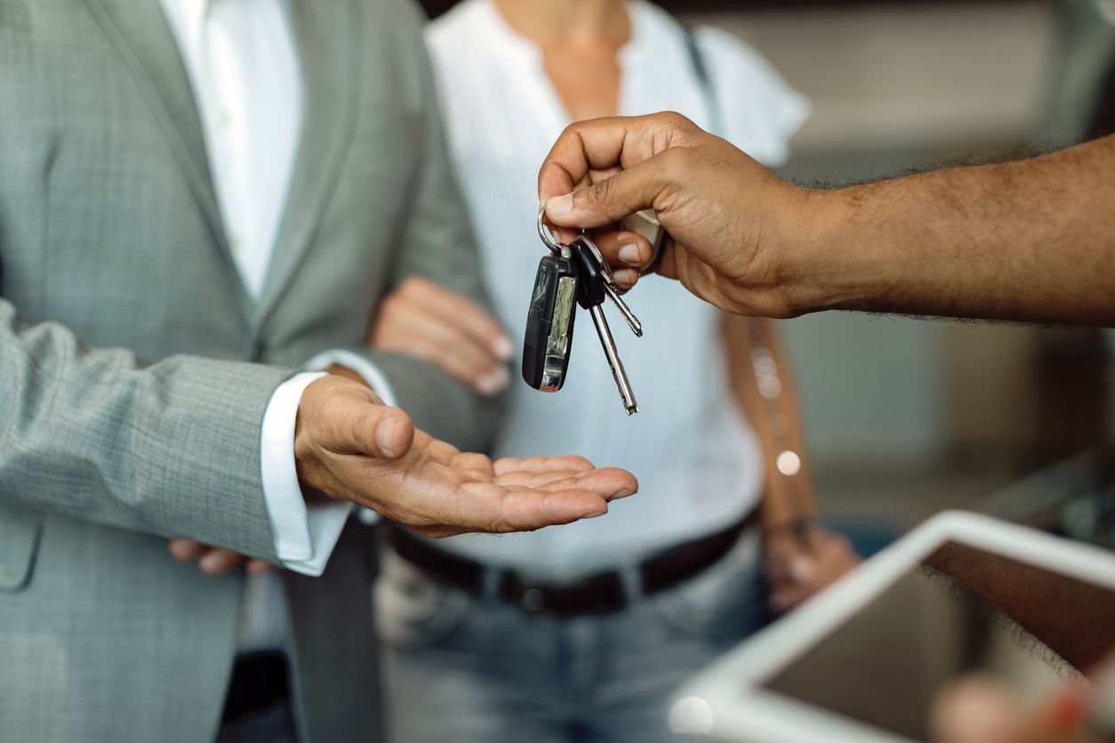 Two people receiving car keys.