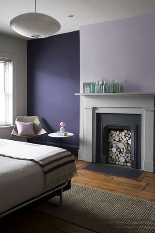 A bedroom with purple and lavender walls