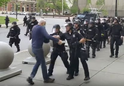 This June 4, 2020, file image from video provided by WBFO, a Buffalo police officer appears to shove a man who walked up to police in Buffalo, N.Y.