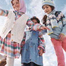 Three kids wearing winter clothes