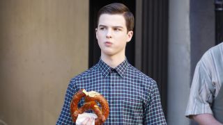 Sheldon holding a big pretzel in Young Sheldon
