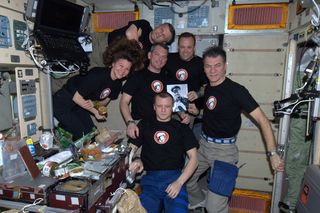 Spaceflyers onboard the International Space Station do dinner and a movie for Yuri's Night on April 12, 2011.