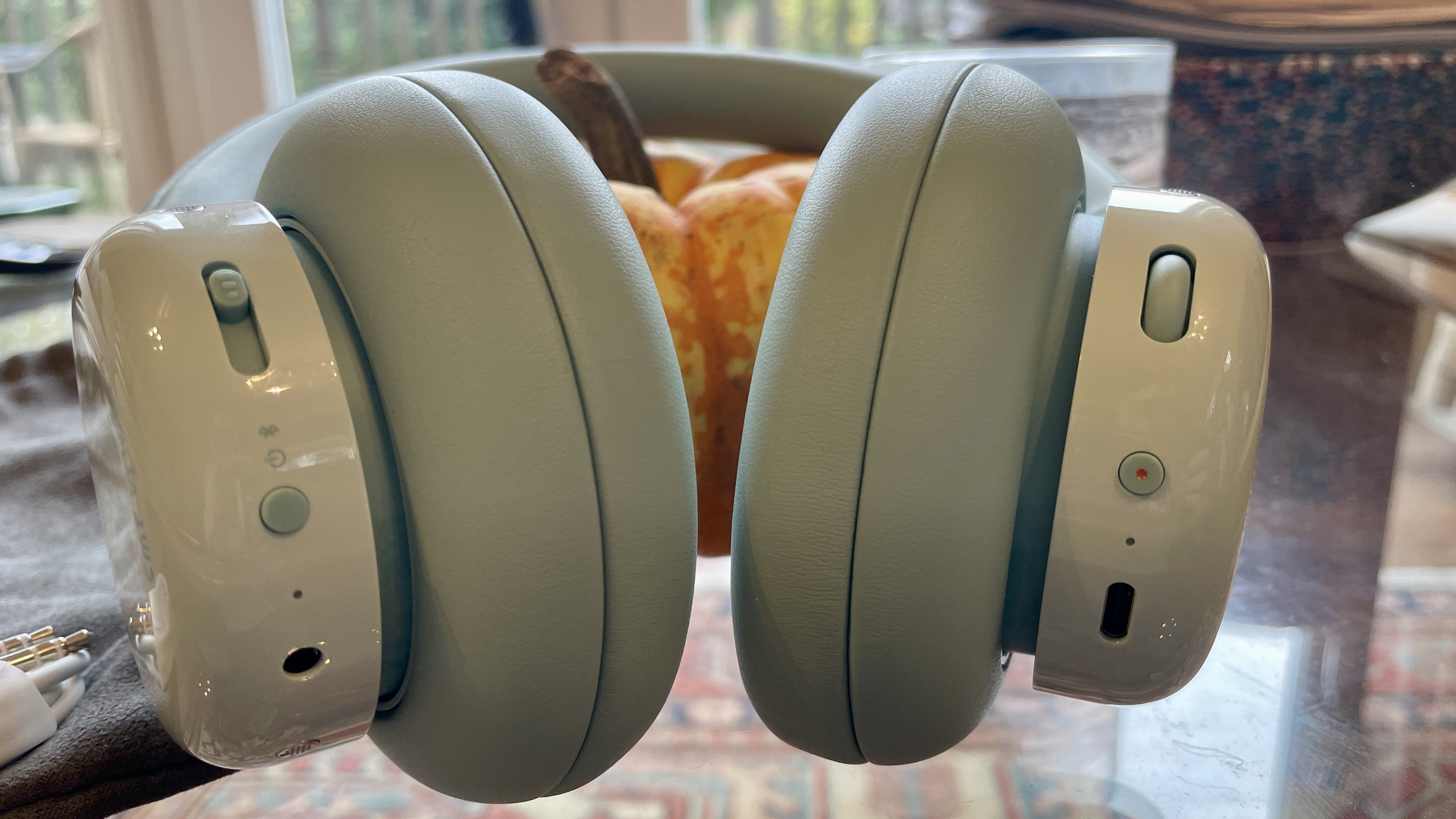 CMF Headphone Pro either beside Nothing Headphone (1) or on a table, with the accessories in the box